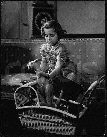 5_year_old_Princess_Margriet_the_puts_her_toy_kangaroo_into_a_pram_ca._1950___Soestdijk.JPG