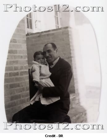 Farah Diba in the arms of her father.jpg
